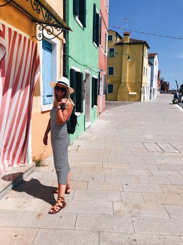 Jenn on a colorful street in Burano